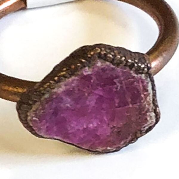 detail of raw ruby and copper ring